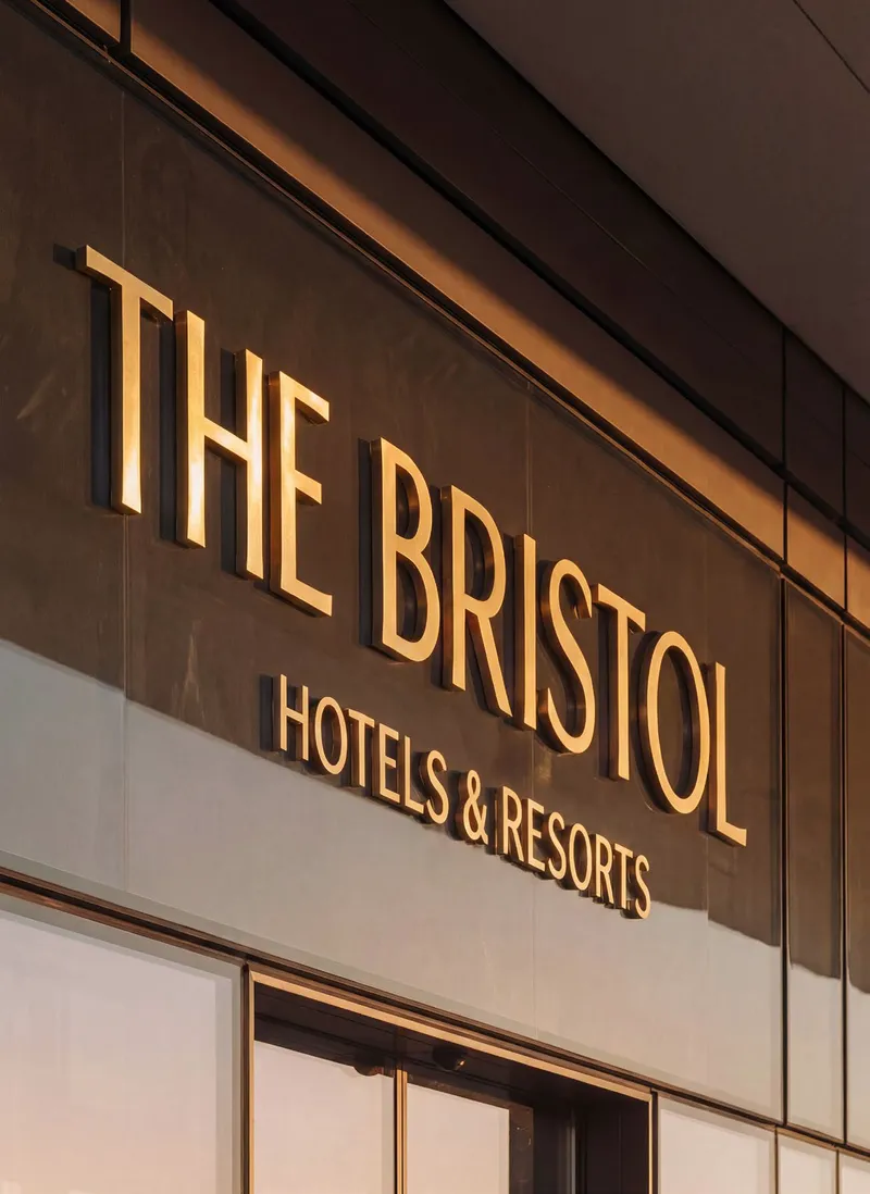 The Bristol Hotels & Resorts name in gold on the facade, developer render
